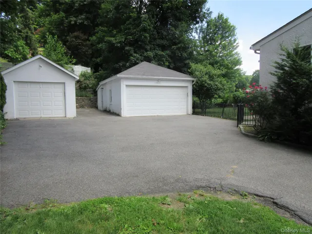 a view of a house with a yard and garage
