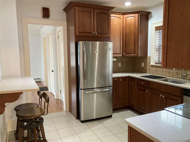 a kitchen with granite countertop a refrigerator and a sink