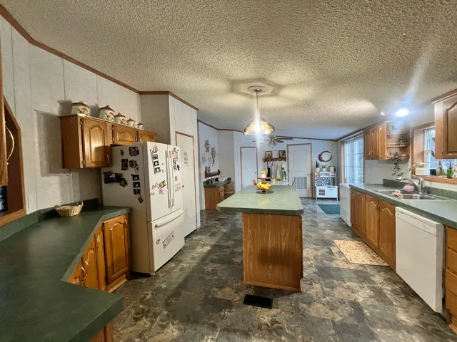 a kitchen with refrigerator and window