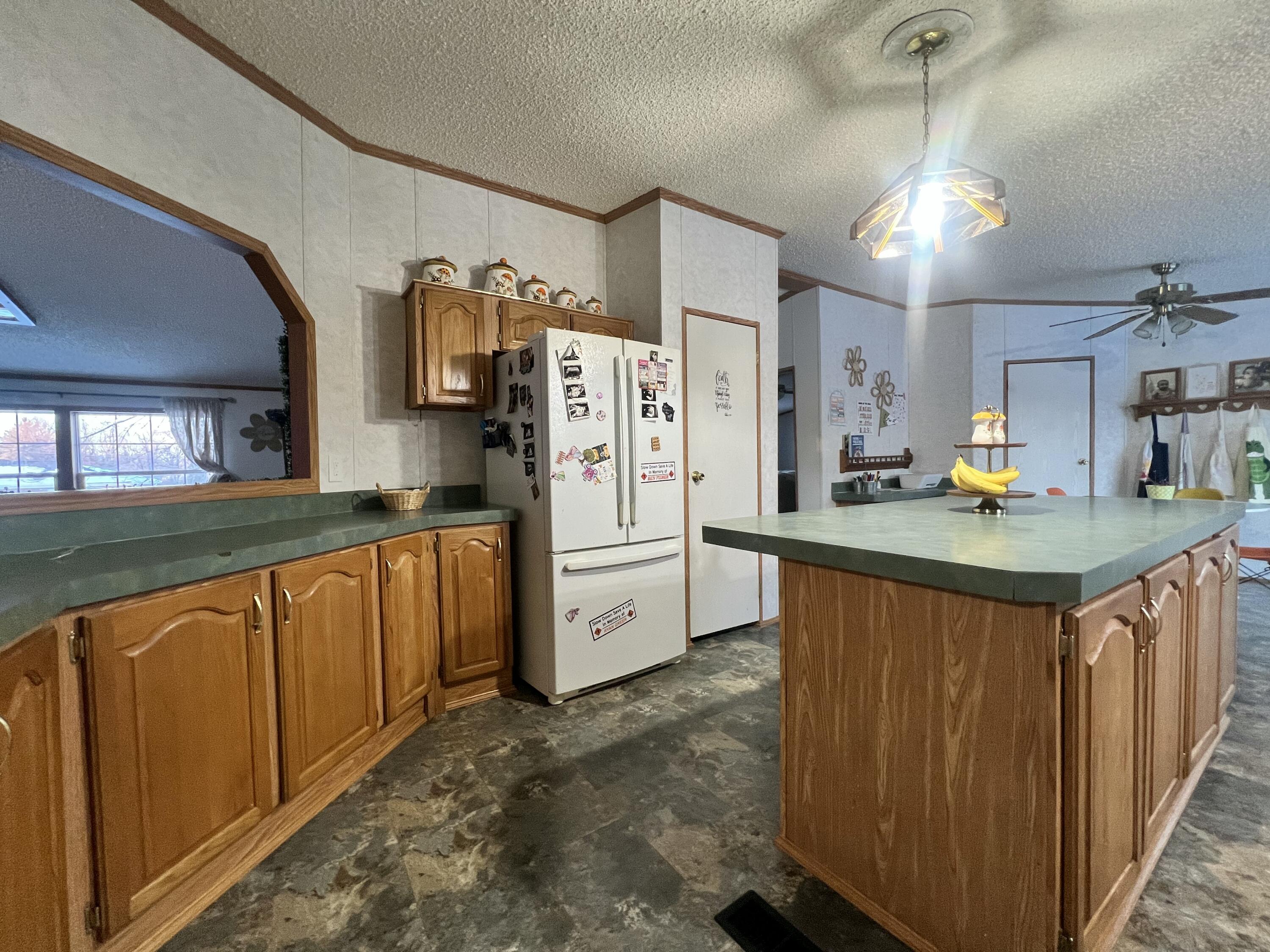 3665 Leslie Street North Judson, IN 46366 - Photo 13 of 39 a kitchen with stainless steel appliances granite countertop a refrigerator a sink dishwasher a stove and a wooden cabinets