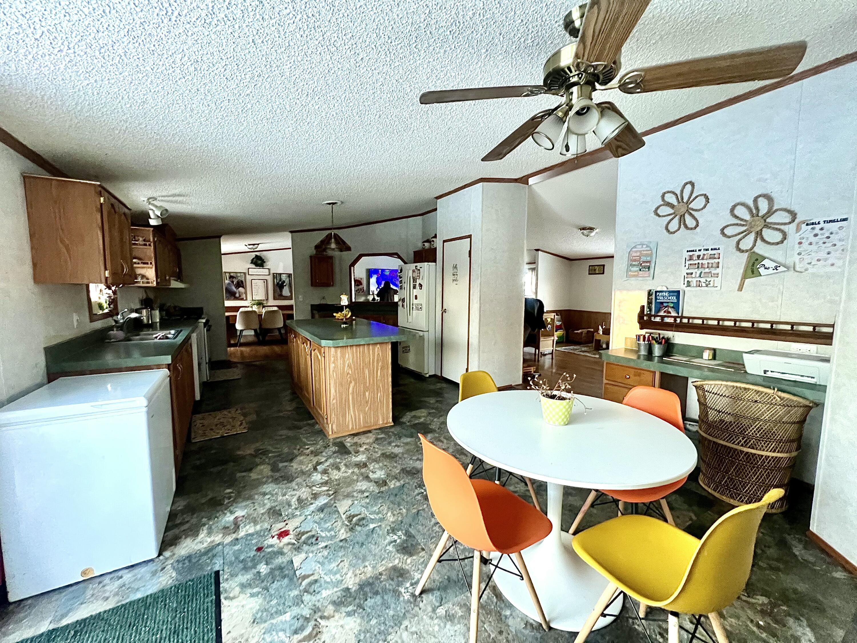 3665 Leslie Street North Judson, IN 46366 - Photo 14 of 39 a kitchen with sink a stove and chairs with wooden floor
