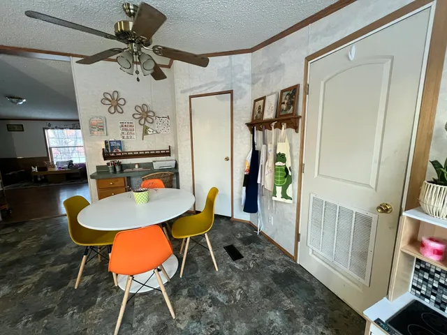 a view of a dining room with furniture and a chandelier