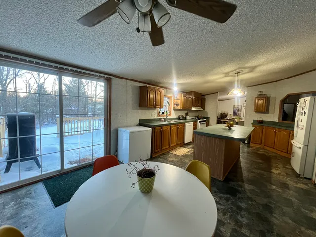 a kitchen with stainless steel appliances granite countertop a sink a stove and a refrigerator