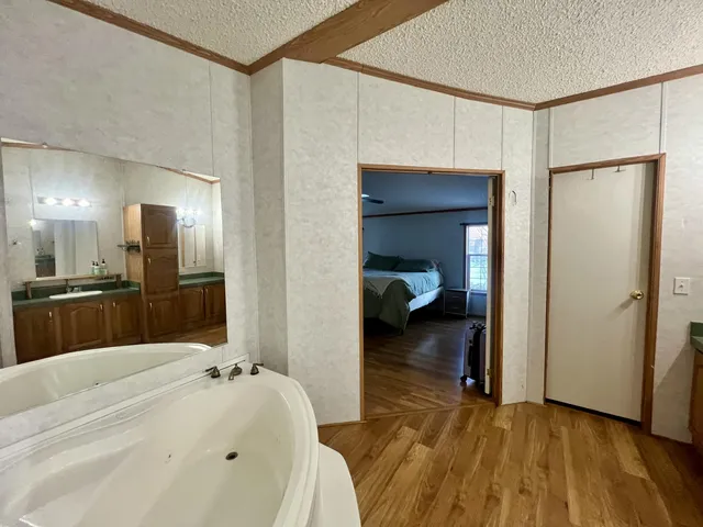 a en suite bathroom with a sink and a large mirror