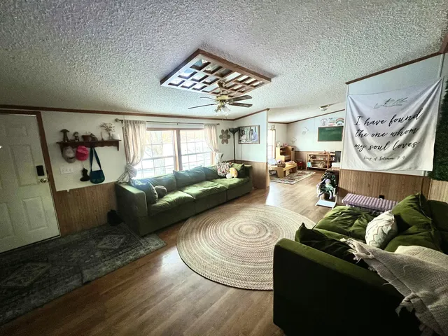 a living room with furniture and wooden floor