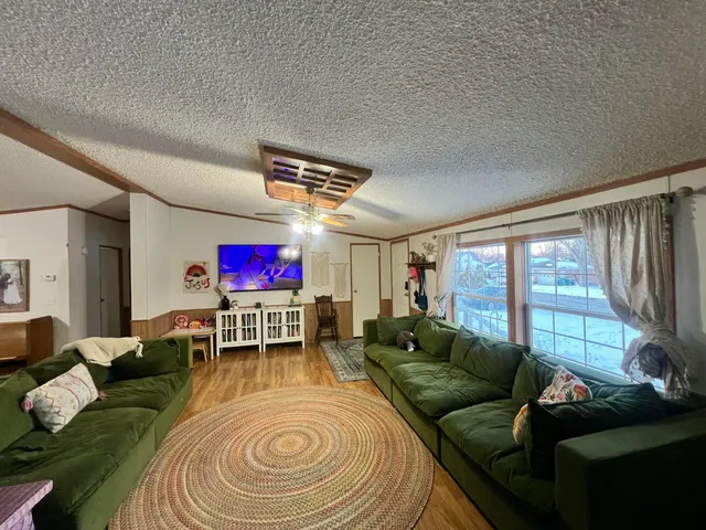 a living room with furniture and a floor to ceiling window