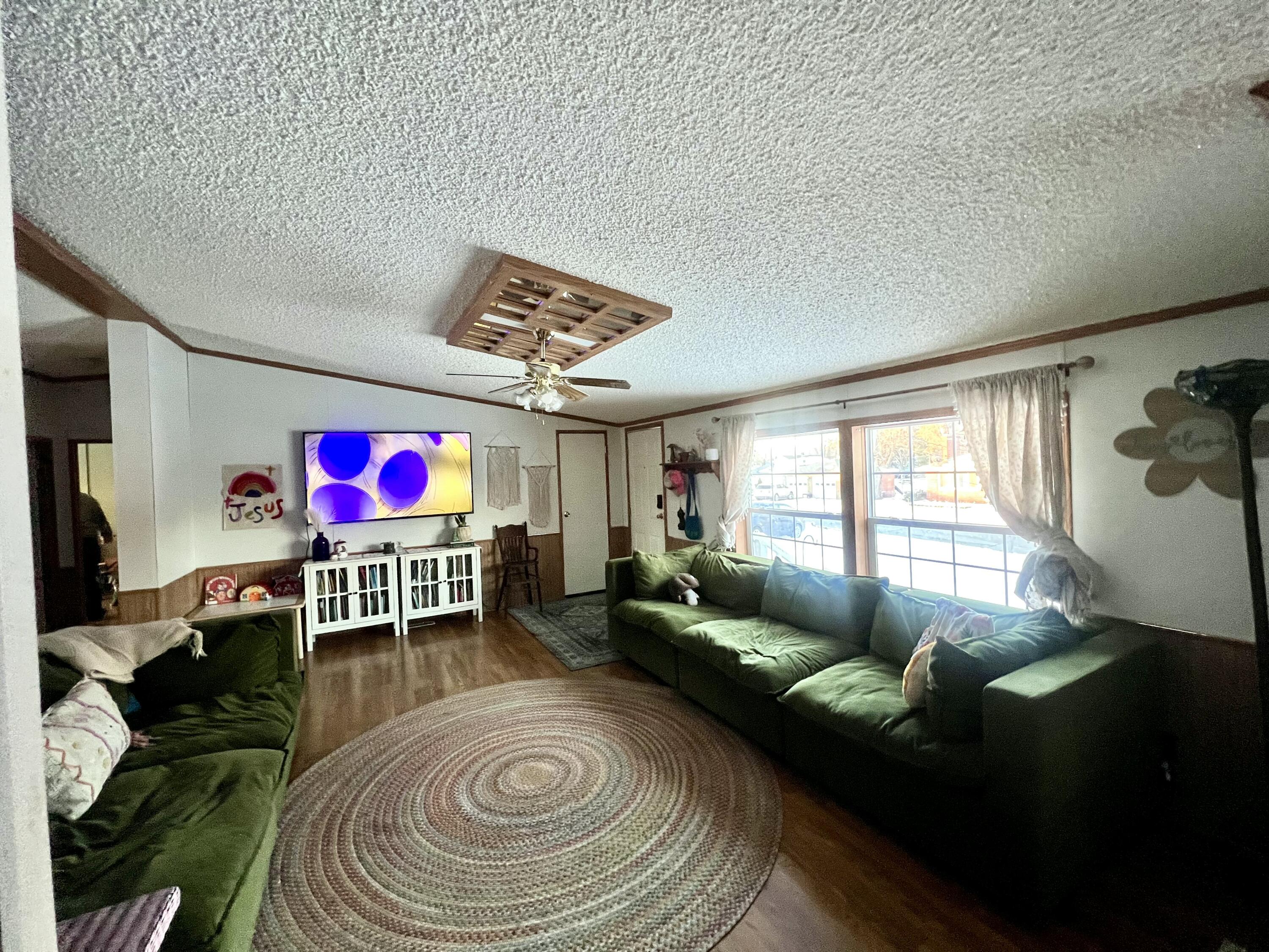 3665 Leslie Street North Judson, IN 46366 - Photo 6 of 39 a living room with furniture and a flat screen tv