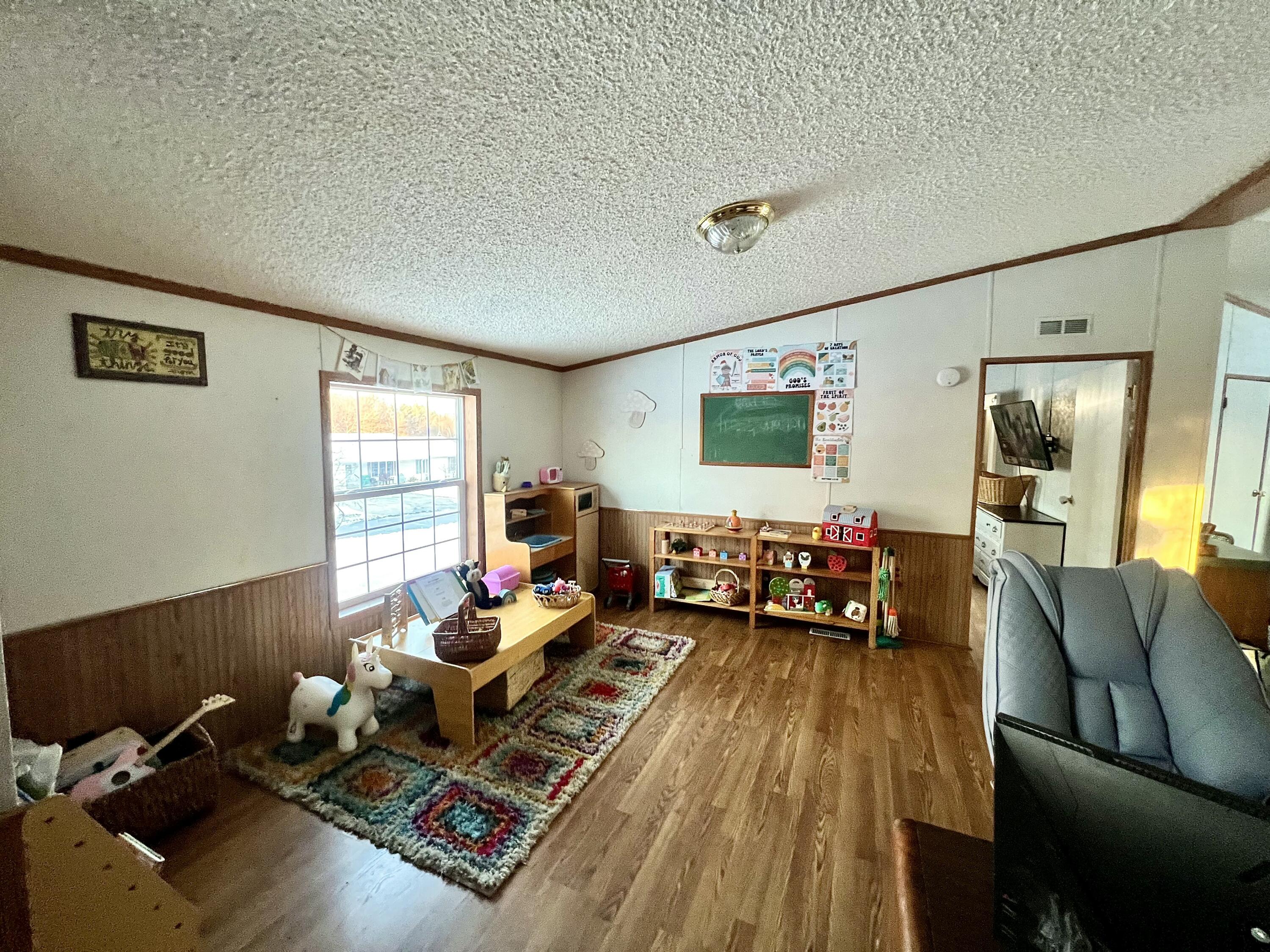 3665 Leslie Street North Judson, IN 46366 - Photo 7 of 39 a living room with furniture and a flat screen tv
