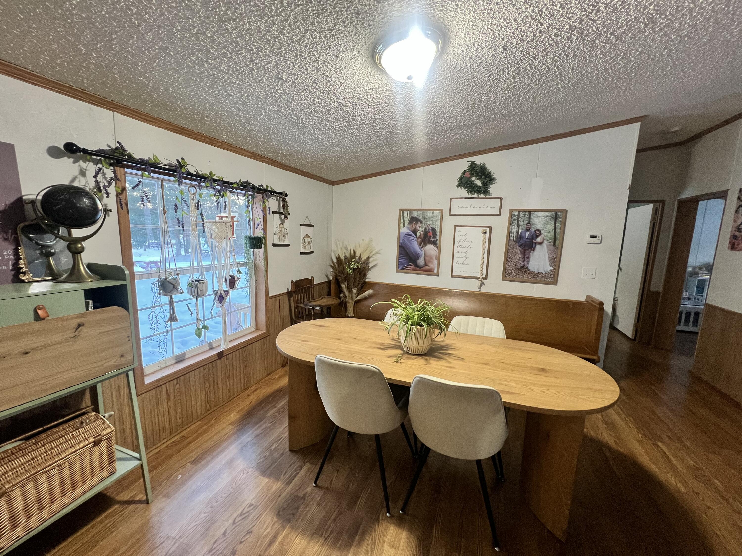 3665 Leslie Street North Judson, IN 46366 - Photo 9 of 39 a view of a dining room with furniture and wooden floor