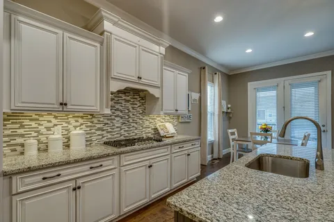 a kitchen with sink and cabinets