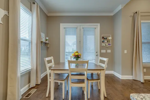a view of a dining room with furniture and a window