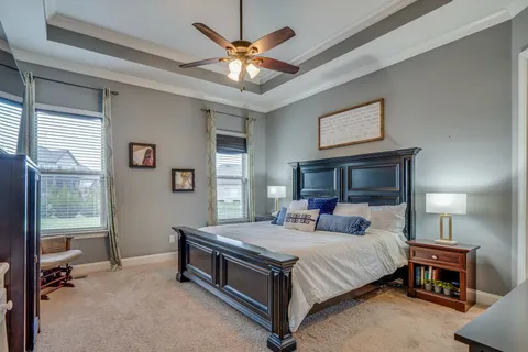 a bedroom with a bed and a chandelier