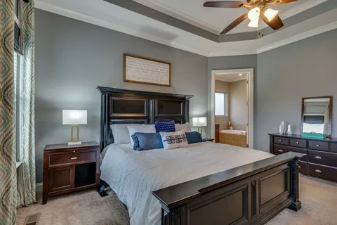 a bedroom with a bed and a chandelier