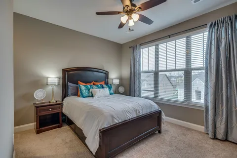 a bedroom with a bed lamp and window