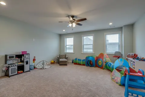 a living room with lots of furniture and toys