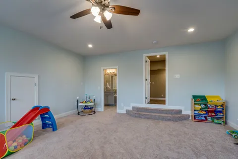 a living room with furniture and a gym equipment