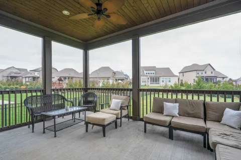 a balcony with furniture and a potted plant