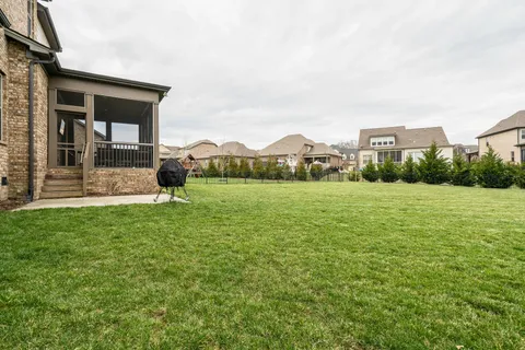 a view of a house with a yard and sitting area