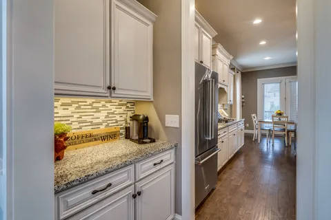 a kitchen with sink refrigerator and cabinets