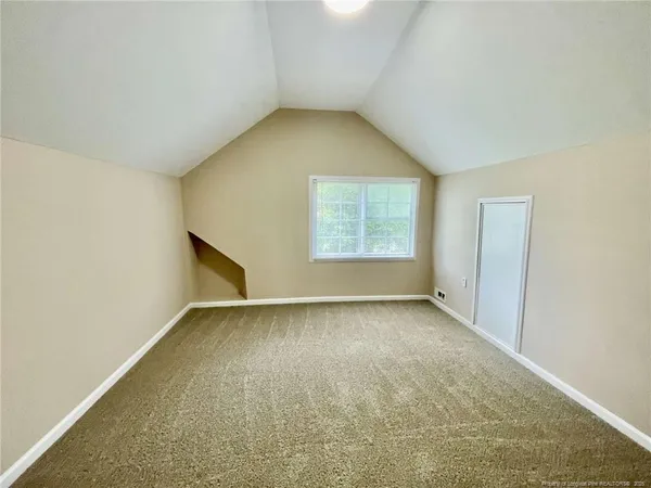 an empty room with a empty space and windows