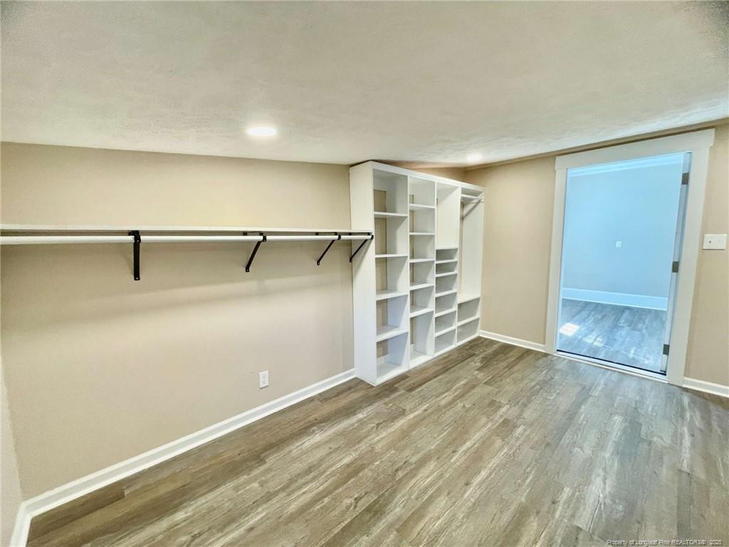 416 Old Maxton Road Raeford, NC 28376 - Photo 18 of 26 an empty room with wooden floor cabinet and windows