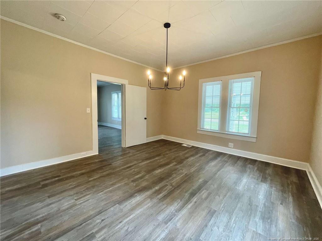 416 Old Maxton Road Raeford, NC 28376 - Photo 2 of 26 an empty room with wooden floor and windows