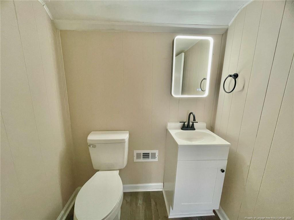 416 Old Maxton Road Raeford, NC 28376 - Photo 25 of 26 a bathroom with a toilet a sink and mirror