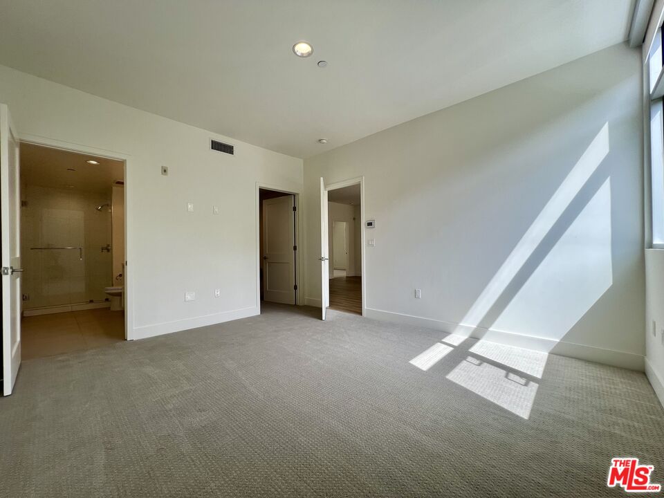 11715 Bellagio Road, Unit 204 Los Angeles, CA 90049 - Photo 10 of 27 an empty room with windows