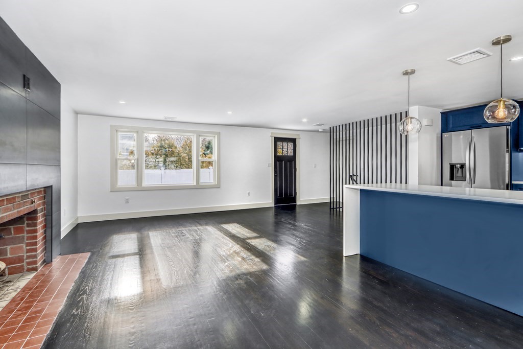 11 Spring Lane Saugus, MA 01906 - Photo 11 of 31 a view of an empty room with a window and wooden floor