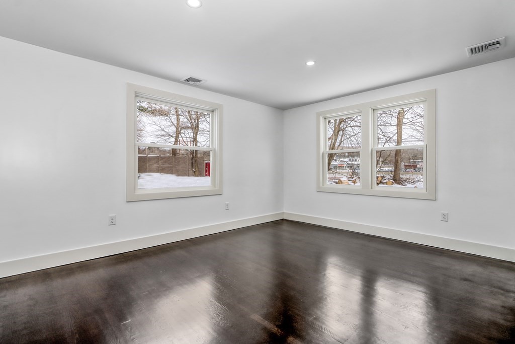 11 Spring Lane Saugus, MA 01906 - Photo 13 of 31 a view of an empty room with a window and wooden floor