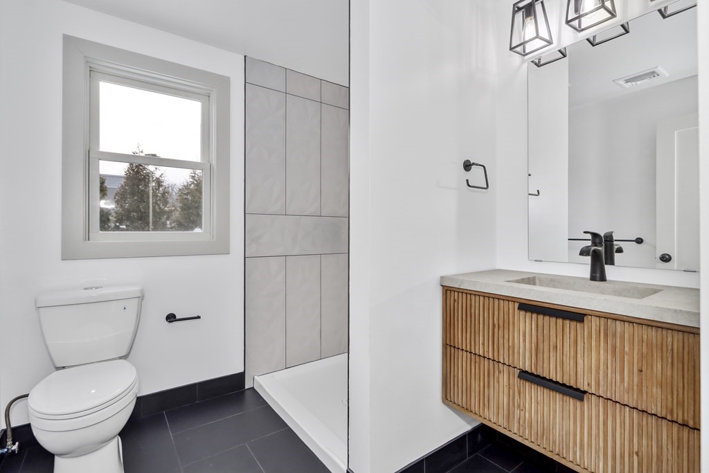 11 Spring Lane Saugus, MA 01906 - Photo 20 of 31 a bathroom with a sink a toilet and shower