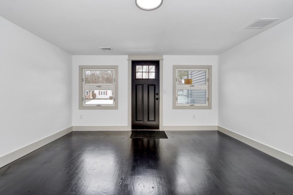 11 Spring Lane Saugus, MA 01906 - Photo 2 of 31 a view of an empty room with wooden floor and a window