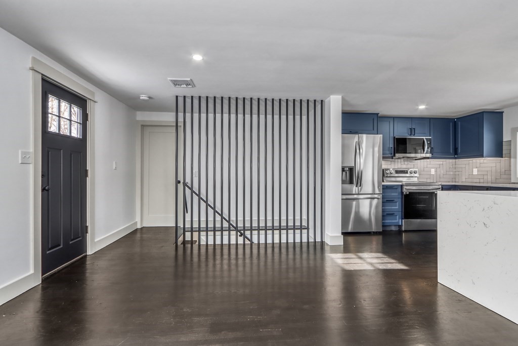 11 Spring Lane Saugus, MA 01906 - Photo 22 of 31 a view of kitchen with stainless steel appliances granite countertop a stove top oven a sink and a refrigerator