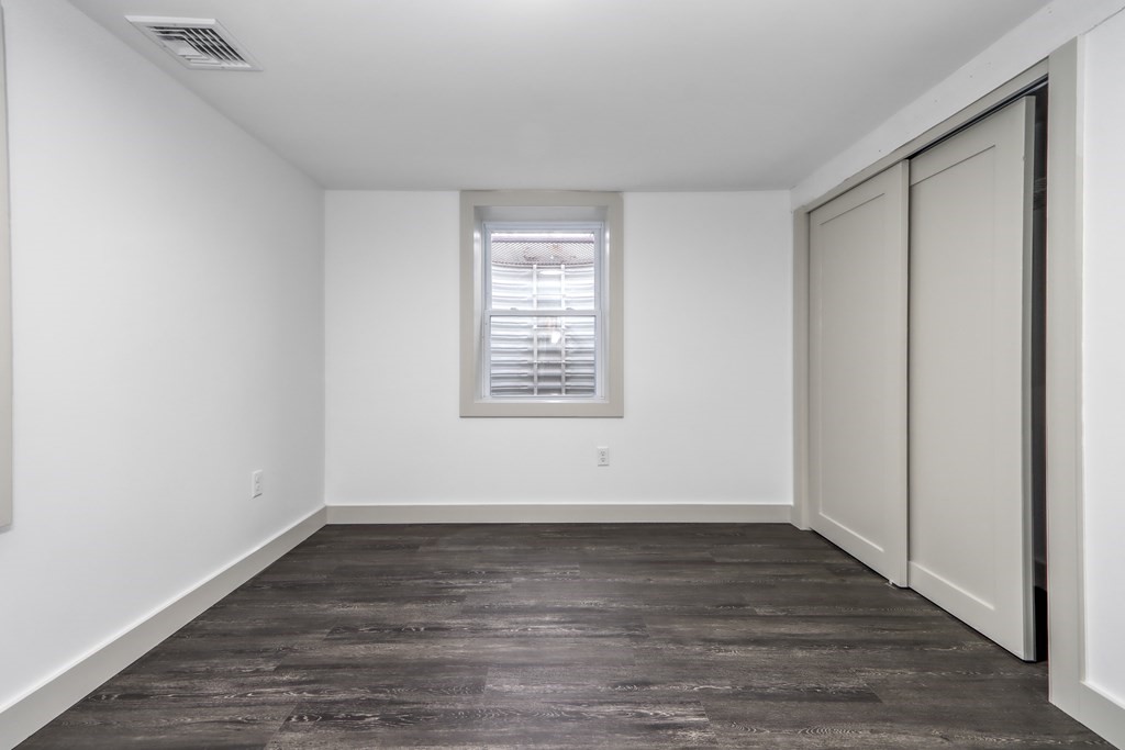 11 Spring Lane Saugus, MA 01906 - Photo 25 of 31 a view of an empty room with wooden floor and a window
