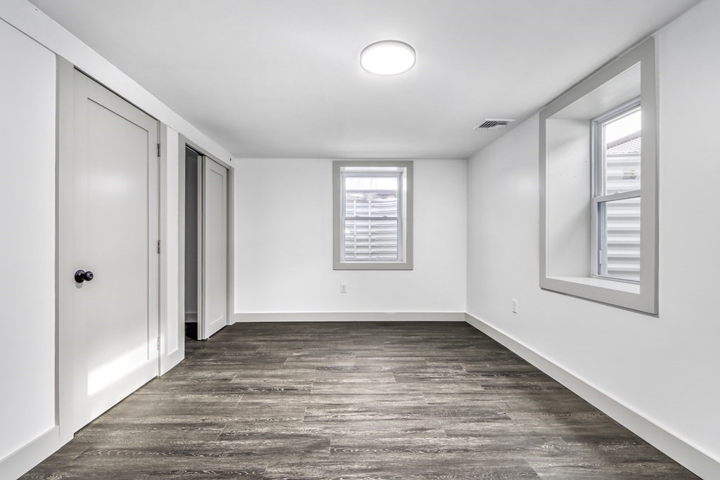 11 Spring Lane Saugus, MA 01906 - Photo 26 of 31 a view of an empty room with wooden floor and a window