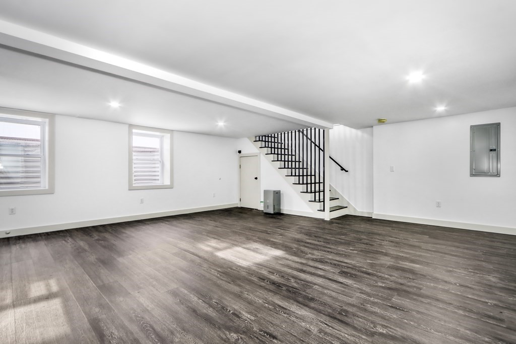 11 Spring Lane Saugus, MA 01906 - Photo 27 of 31 an empty room with wooden floor and white walls