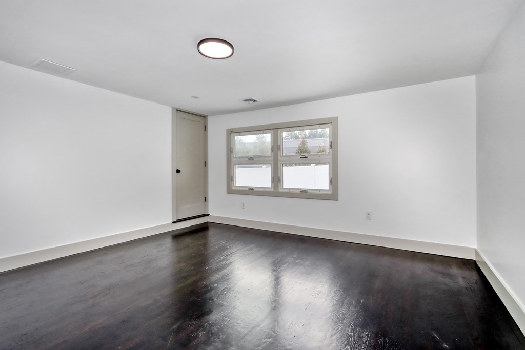 11 Spring Lane Saugus, MA 01906 - Photo 3 of 31 an empty room with wooden floor and windows