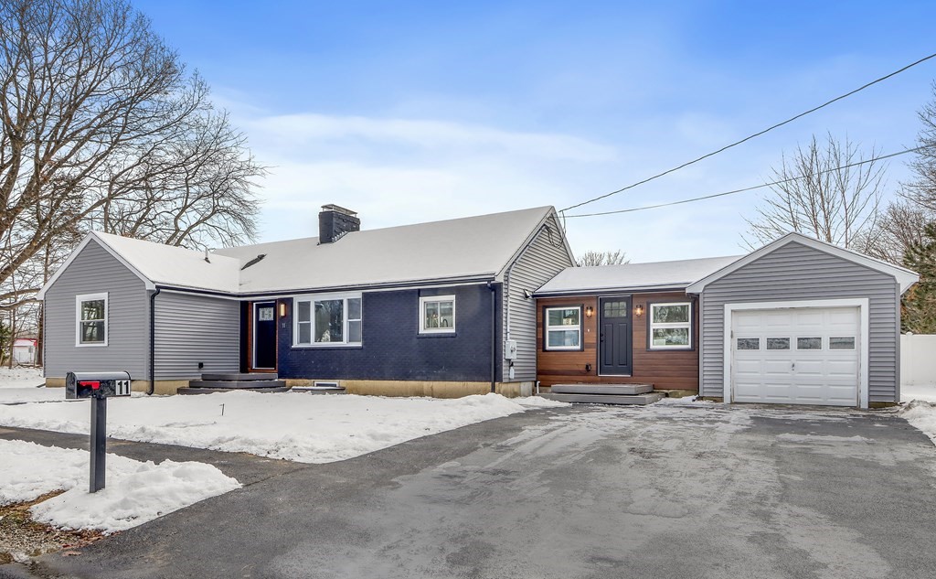 11 Spring Lane Saugus, MA 01906 - Photo 31 of 31 a front view of a house with a yard and garage