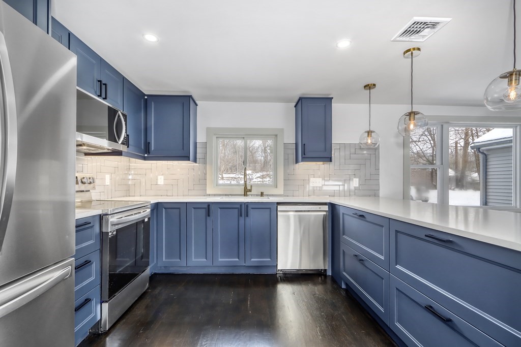 11 Spring Lane Saugus, MA 01906 - Photo 6 of 31 a kitchen with stainless steel appliances granite countertop wooden cabinets a sink and dishwasher