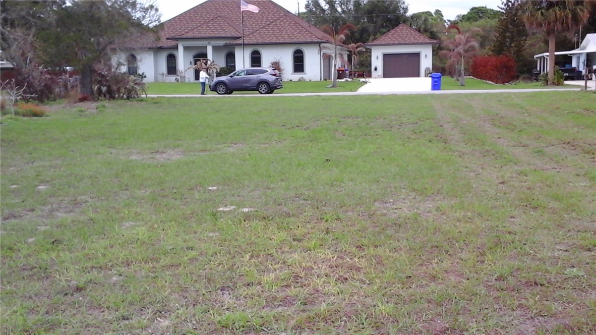 8065 126th Street Sebastian, FL 32958 - Photo 2 of 25 a house view with a sitting space and garden