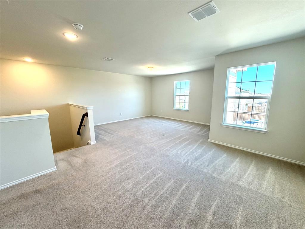 2006 Hummingbird Street Princeton, TX 75407 - Photo 12 of 23 an empty room with windows and closet