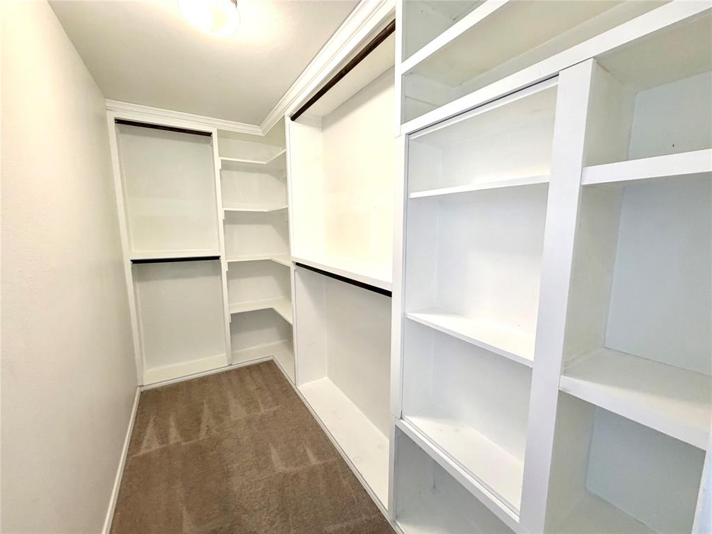 2006 Hummingbird Street Princeton, TX 75407 - Photo 21 of 23 a view of walk in closet with empty racks