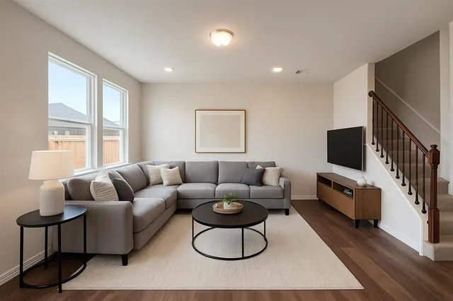a living room with furniture a flat screen tv and a large window