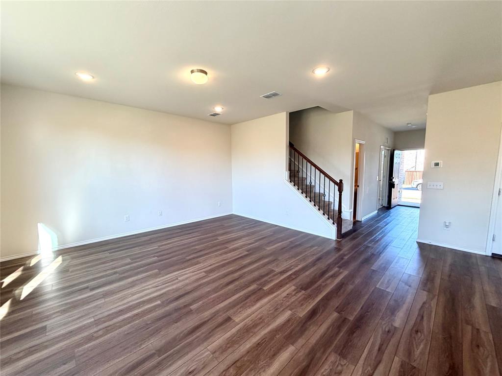 2006 Hummingbird Street Princeton, TX 75407 - Photo 5 of 23 a view of an empty room with wooden floor