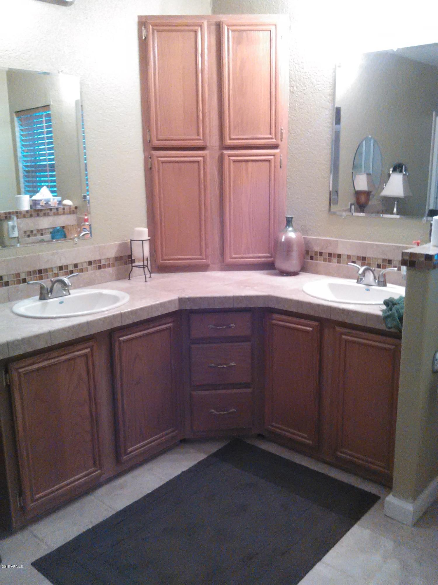 1829 West Irvine Road Phoenix, AZ 85086 - Photo 17 of 33 a bathroom with a double vanity sink and a mirror