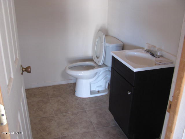 1829 West Irvine Road Phoenix, AZ 85086 - Photo 31 of 33 a white toilet sitting next to a bathroom sink