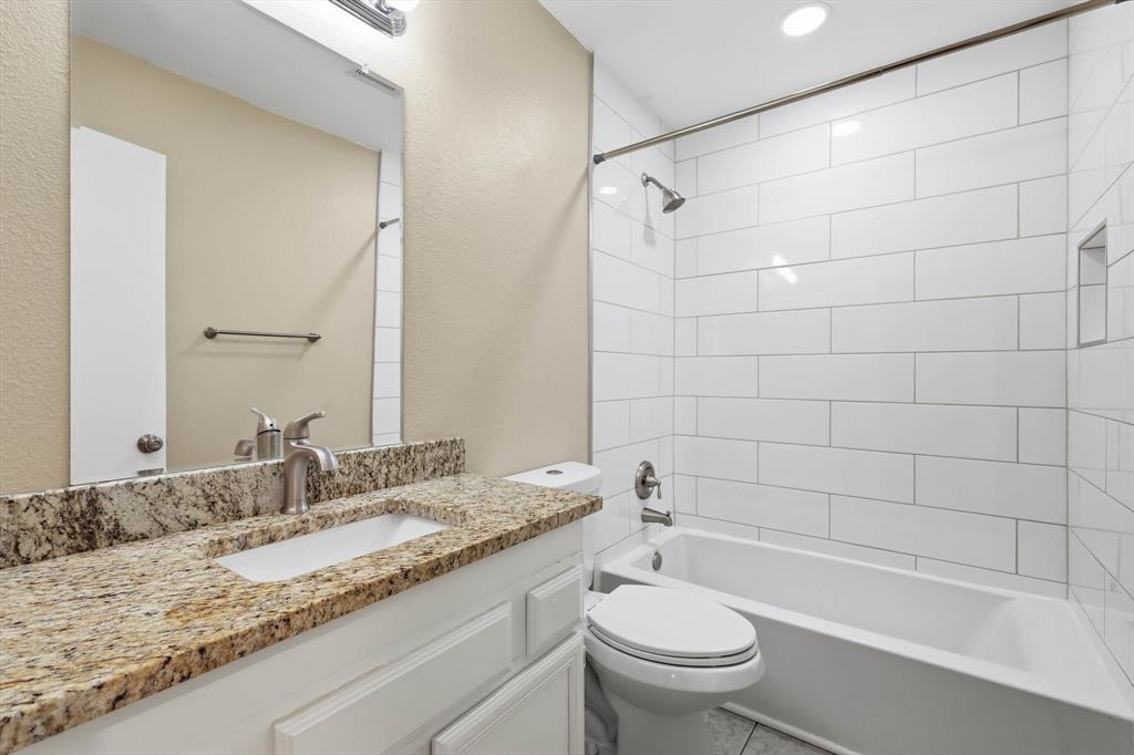 7733 Liz Lane Watauga, TX 76148 - Photo 21 of 27 Full bath with vanity and bathtub / shower combination