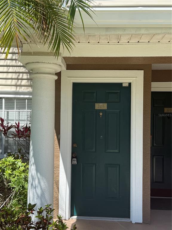 8932 Manor Loop, Unit 205 Lakewood Ranch, FL 34202 - Photo 2 of 15 a front view of a house with a porch