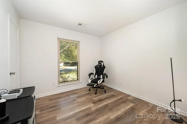 a view of a yard with a house and large tree