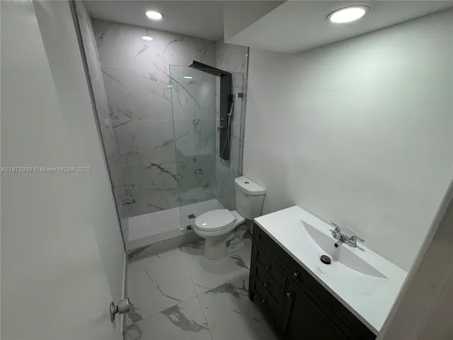 a bathroom with a toilet a sink and shower